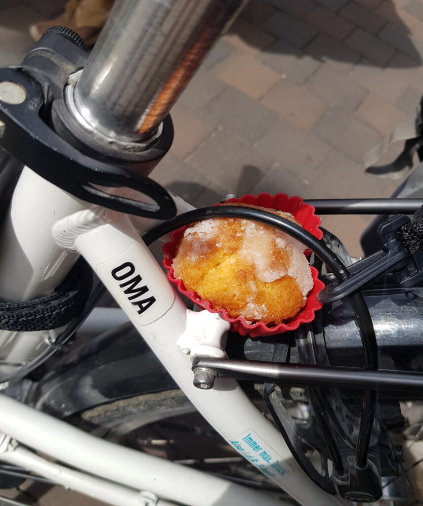 MUT-TOUR: Sucht_Zucker_Depression Zuckriger Muffin eingeklemmt hinter der Tandemlenkstange